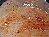 Frying curry paste in coconut cream