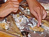 Pulling apart catfish meat into flakes