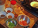 Ground spices await, garlic sizzles in the wok
