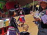 Kasma handing out candy, Hmong New Year 2013 at Mae Sa Mai