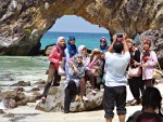 Ferry passengers posing in front of the arch on Koh Khai