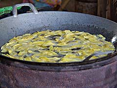 Banana strips frying in a wok, near Ayutthaya