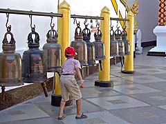 Young bell ringer at Wat Prathat Doi Suthep
