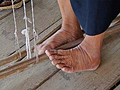 Experienced feet working the loom at Sathorn Museum