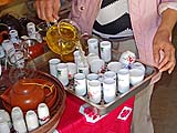 Filling cylinders and inverting them into tasting cups, Ban Rak Thai
