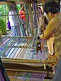 Adjusting threads on the loom, Pa-Da Cotton Textile Museum