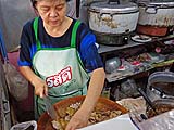 Proprietor slicing duck, noodle shop, Sukhothai
