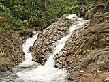Water finding its way around a rock at Borripat Waterfall