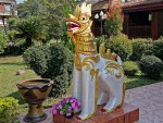 Singh guarding teak building at Wat Nantaram, Chiang Kham
